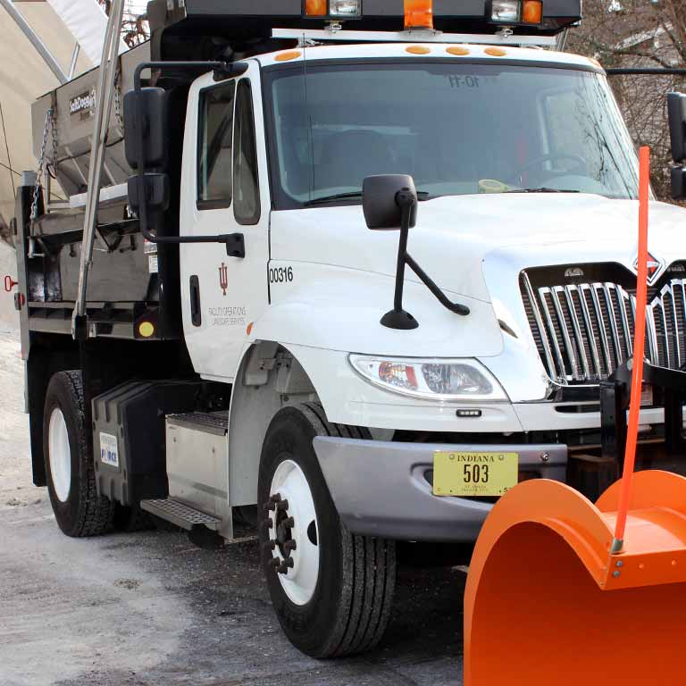 A large truck with a snowplow on the front